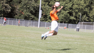Heads up: Lev Zemlyanov '15 heads a ball during practice. In both girls' and boys' soccer, heading is considered an important skill to have.